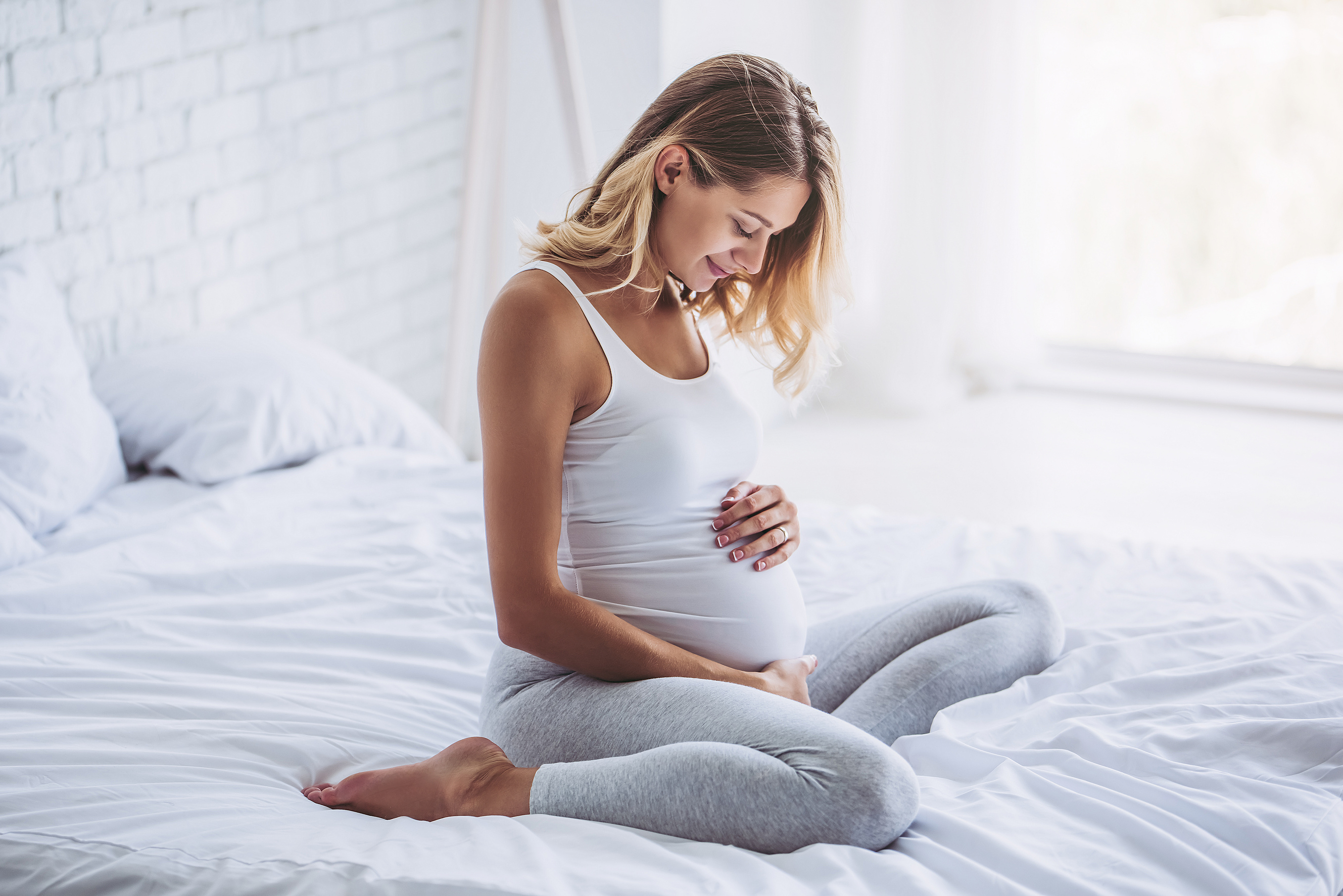 Pregnant Woman Sitting on the Bed